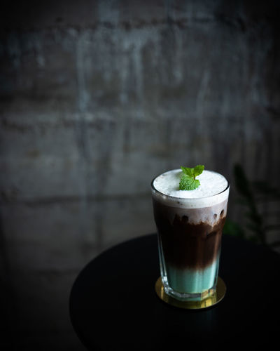 Close-up of coffee on table against wall