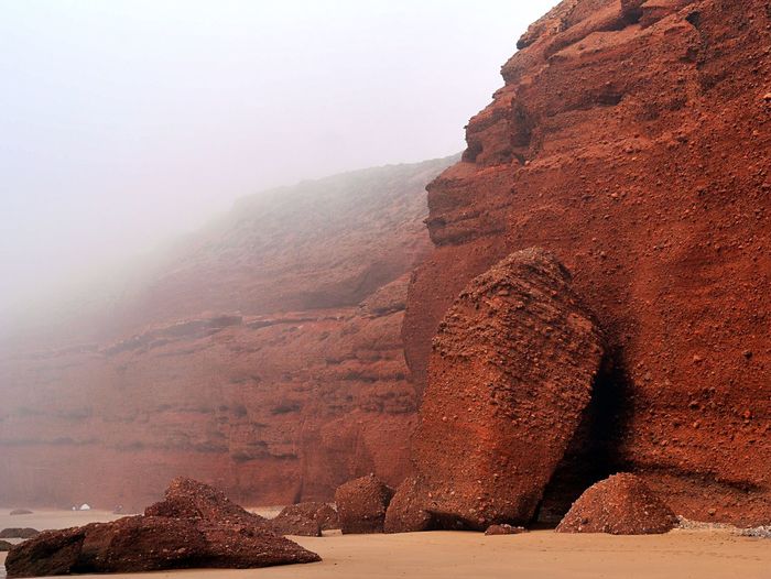 Moroccan mistic foggy landscape of clay rocks at seaside