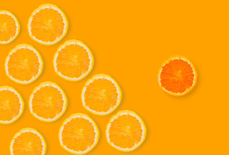 Close-up of orange slices over white background