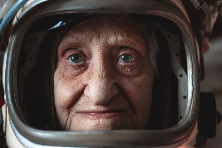 Close-up portrait senior woman wearing space suit