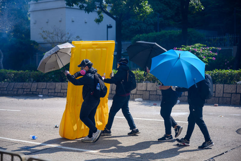 People with umbrella on wet street