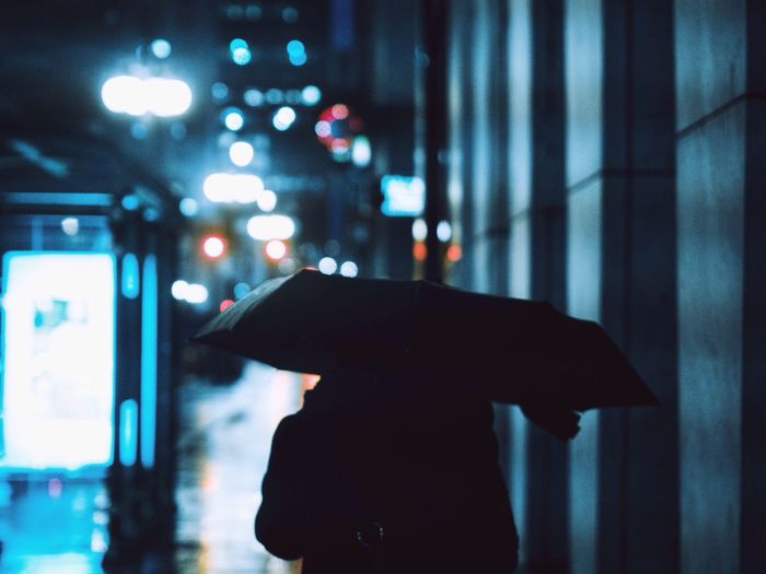 Woman looking at illuminated light