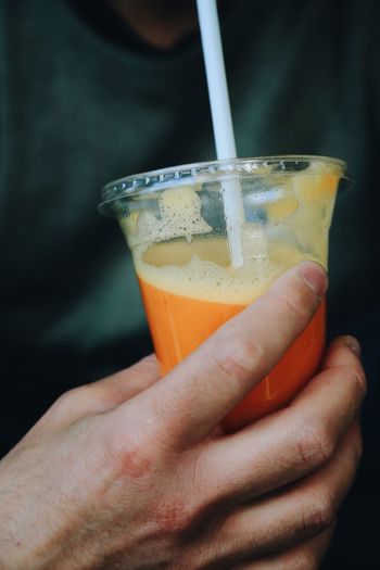 Midsection of man having drink