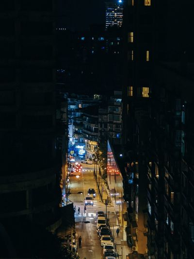 High angle view of illuminated street amidst building at night