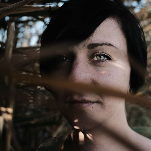 Close-up portrait of young woman with gray eyes