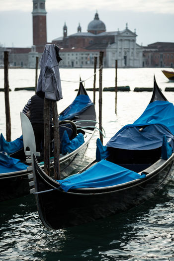 Gondolas moored on grand canal in city