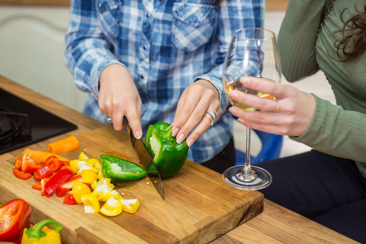 Midsection of woman preparing food on cutting board