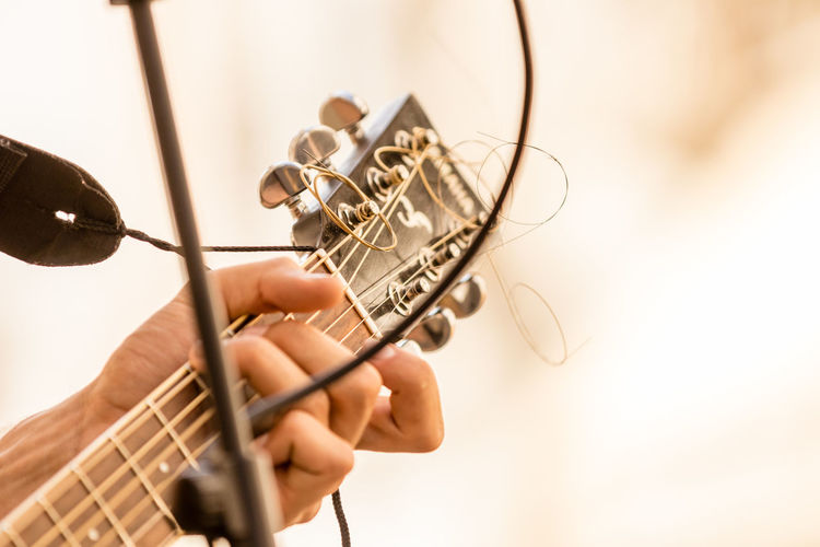 Close-up of hand playing guitar