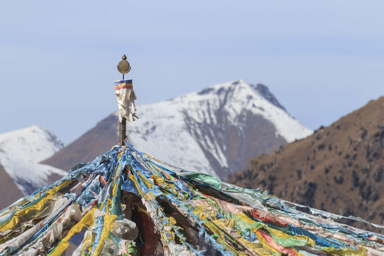 Close-up of prayer flags on mountain against clear sky