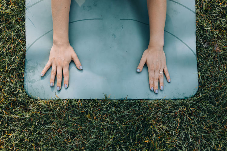 High angle view of woman stretching on a yoga mat 