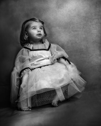 Black and white dramatic portrait of a little girl