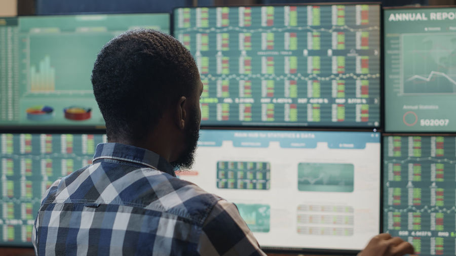 Rear view of trader working in office