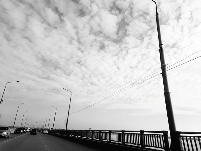 Road by bridge against sky