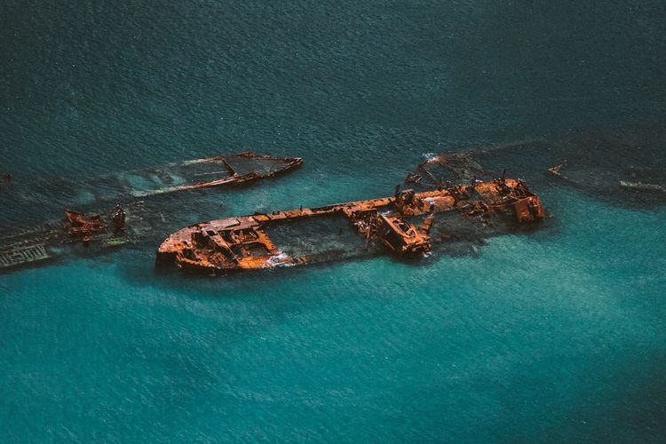 Aerial view of damaged ships in sea