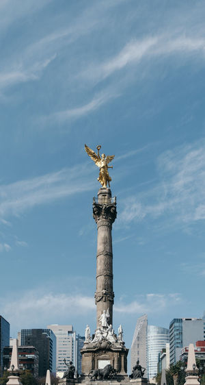 Low angle view of victory column against cloudy sky