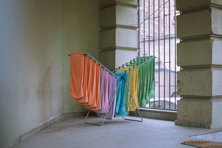 Clothes drying against wall in building