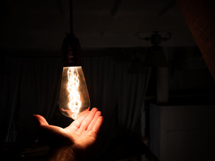 Person holding light bulb
