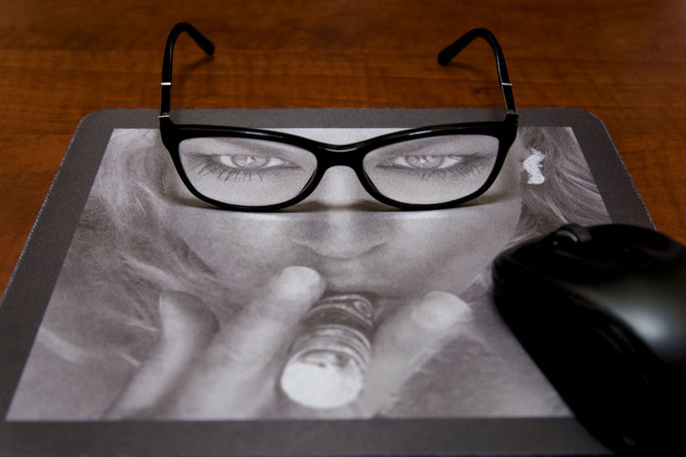 Portrait of man wearing eyeglasses on table