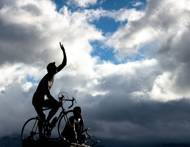 Low angle view of silhouette sculpture against sky