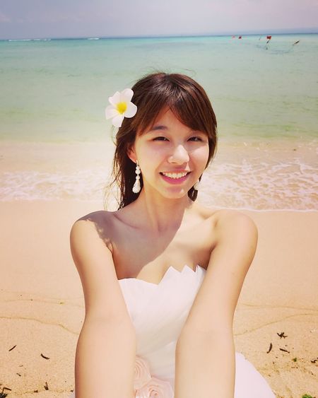 Portrait of smiling young woman at beach