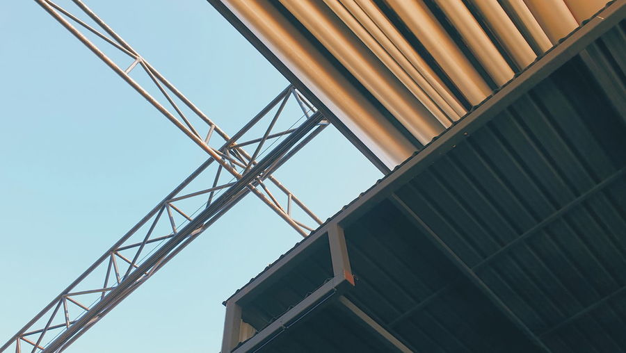 Low angle view of crane against clear sky