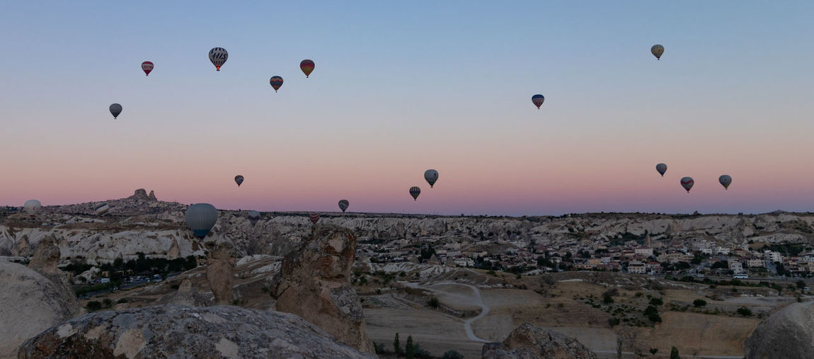 Hot air balloons flying over rocks
