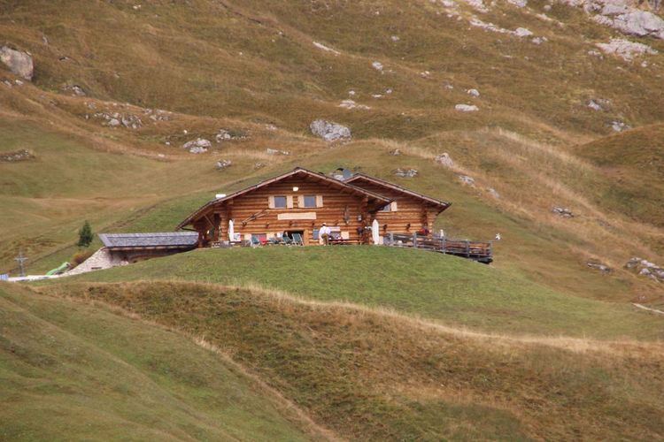 House on field by mountain