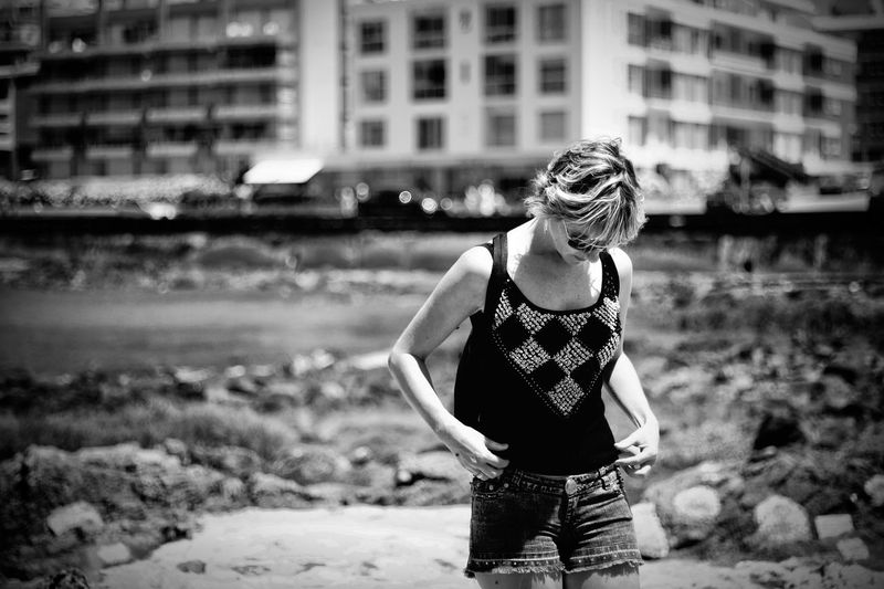 Woman in tank top standing outdoors