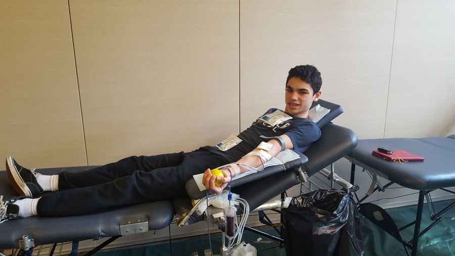 Young man donating blood at hospital