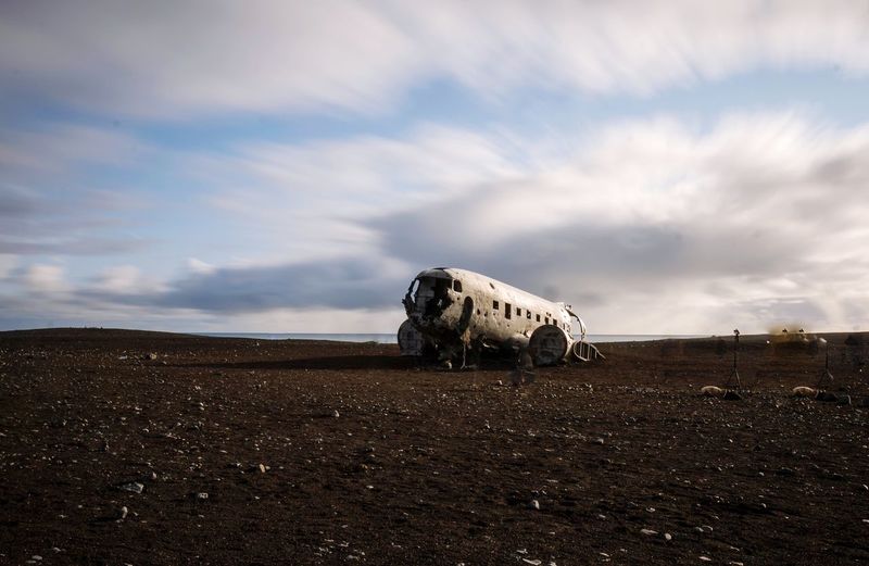 View of crashed plane in iceland against sky