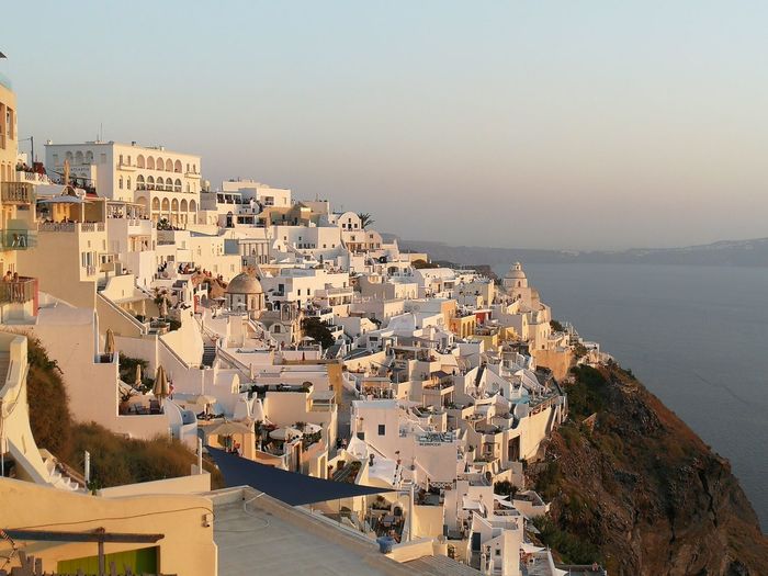 High angle view of town by sea against clear sky