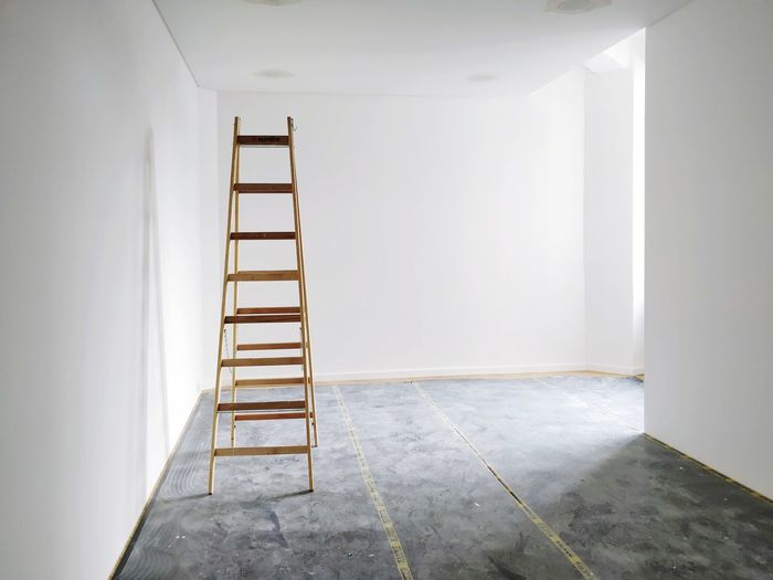 Empty white room with ladder being renovated