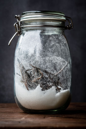 Close-up of ice cream in glass jar on table