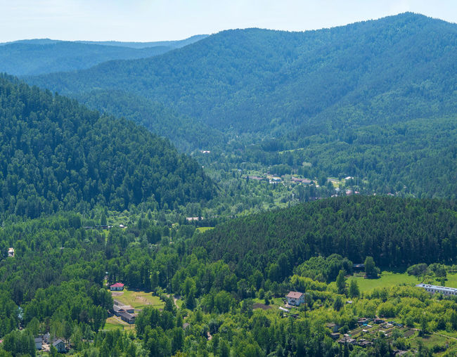 High angle view of trees and mountains against sky