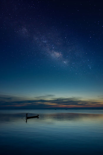Boat in sea against sky at night