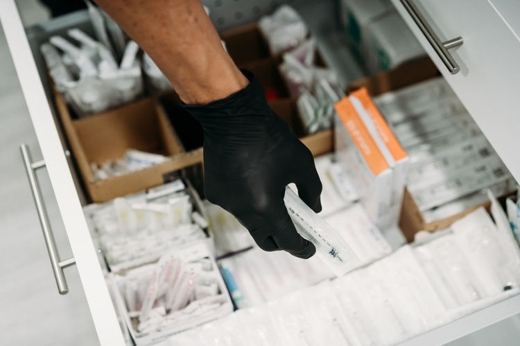 Pharmacist holding medicine box in pharmacy drugstore.