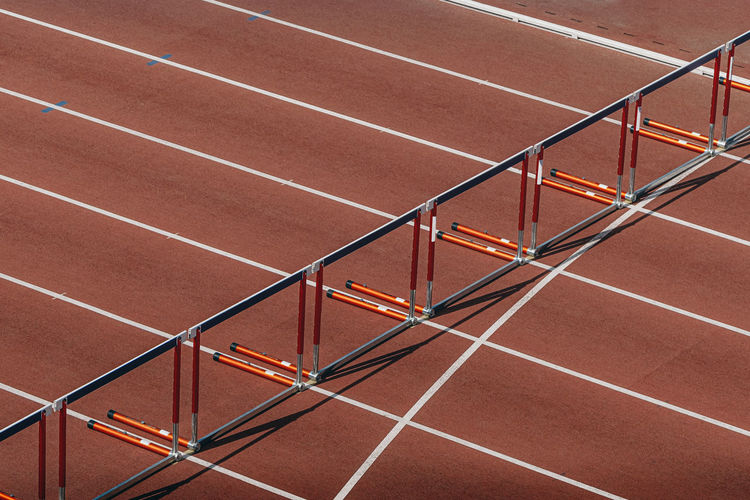 Hurdles for running 110 meters on red track of stadium