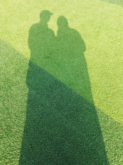 Shadow of people on grass