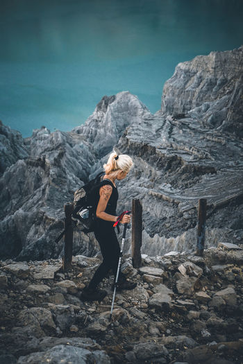 Full length of woman walking on rocky landscape
