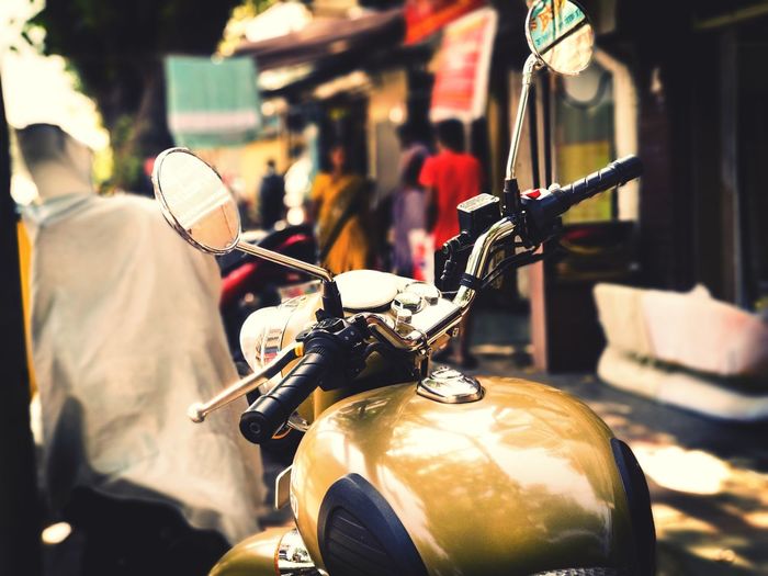 Close-up of motor scooter on street