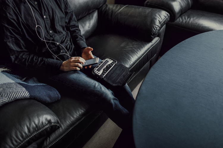 Man sitting on sofa and using braille keyboard