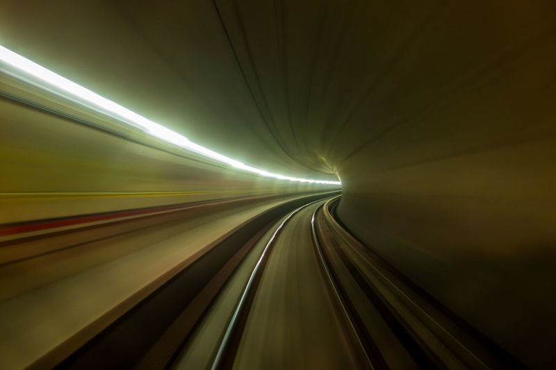 Railroad track in illuminated tunnel