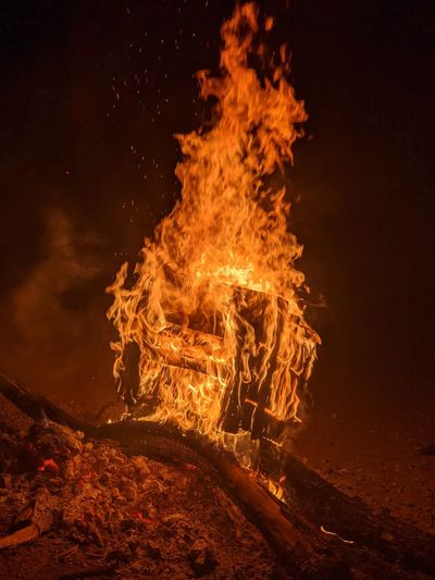 Bonfire on wooden log at night