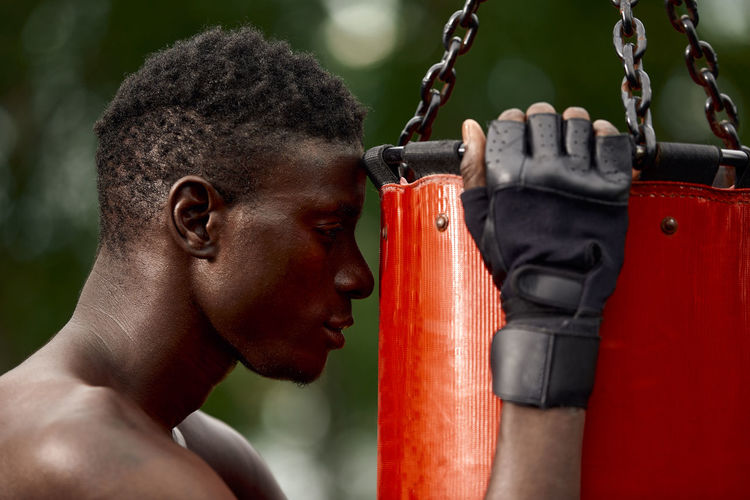 Side view of man holding metal