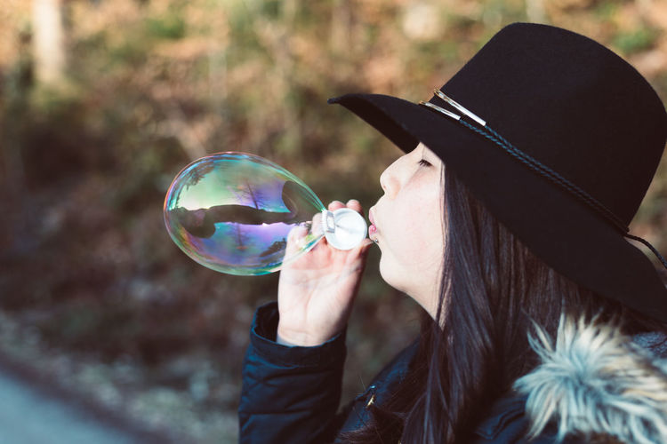 Close-up of young woman with bubble