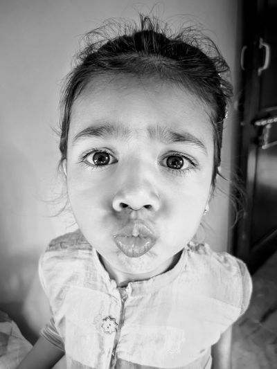 Portrait of cute girl making faces at home