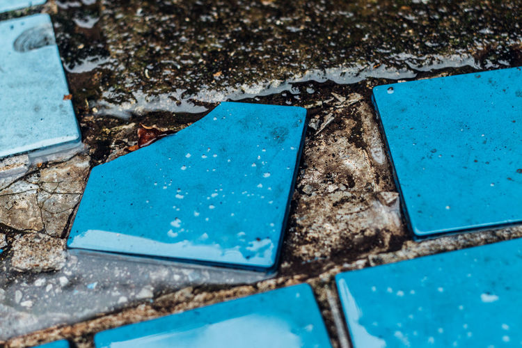 High angle view of wet blue tiles