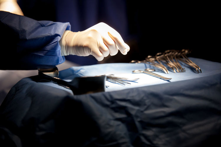 Midsection of doctor working at operating room