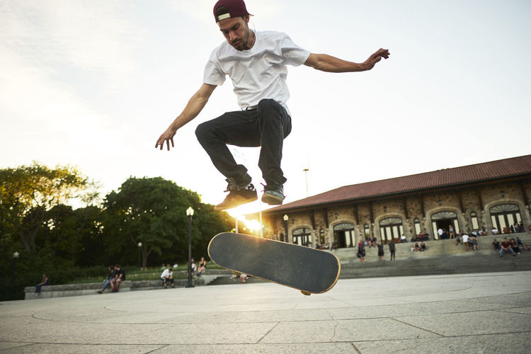 Skateboard enthusiast doing a flip trick while skateboarding