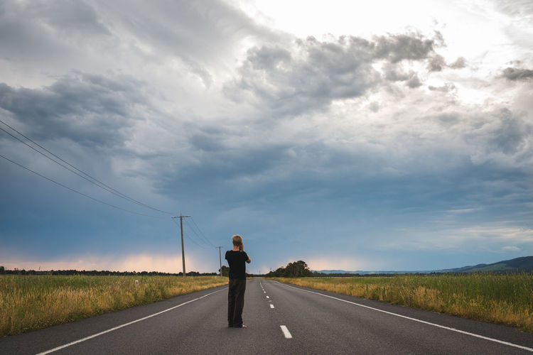 Man on road against sky